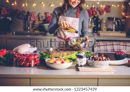 Young Woman Cooking in the kitchen. Healthy Food for Christmas (stuffed duck or Goose)