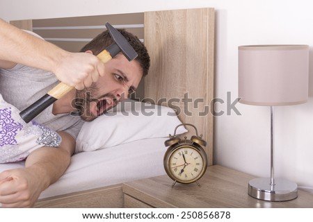 Man wakes up and he is mad at clock ringing