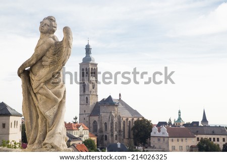 Statue of an angel and church of St. James in historical centre of town Kutna Hora in the Czech republic