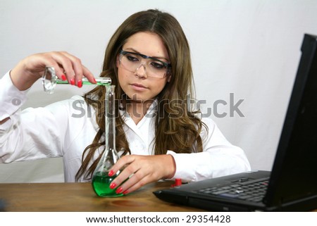 A science student pours a green solution