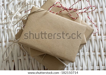 gift box wrapped in recycled paper, with ribbon bow,  with ribbon rustic
