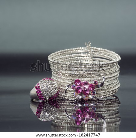 silver bracelet with pink crystal stones and ring. horizontal image