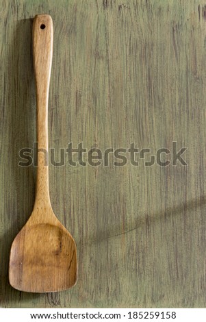 Wooden kitchenware on green background, texture for menus and cooking needs