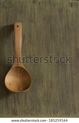 Wooden kitchenware on green background, texture for menus and cooking needs