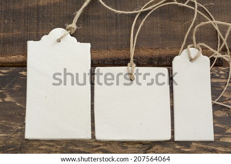 White labels, lace and rustic wooden background thread in geometric shapes