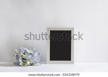 empty picture frame, decorated with blue flowers, white background