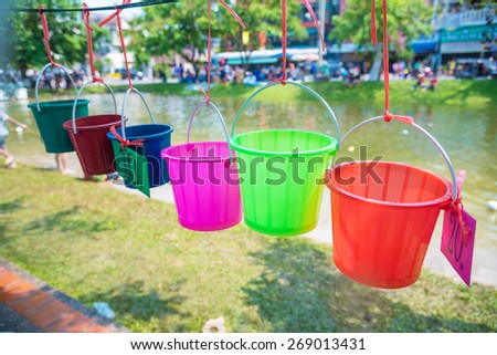 Colorful buckets sales for  pick up a water in water tank to splash to others on Songkran festival, The Thailand traditional