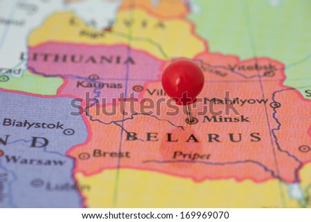 Round red thumb tack pinched through city of Minsk on Belarus map. Part of collection covering all major capitals of Europe.