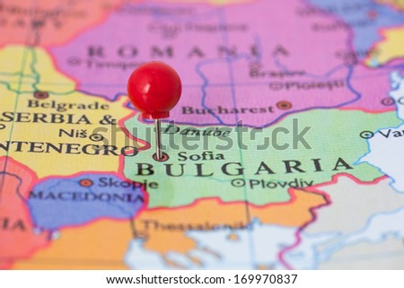 Round red thumb tack pinched through Sofia on Bulgaria map. Part of collection covering all major capitals of Europe.