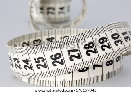 Curled-up measuring tape. Ideal for dieting or weight loss purposes.