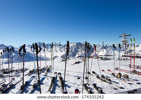 Scattered skis and ski poles at ski resort.