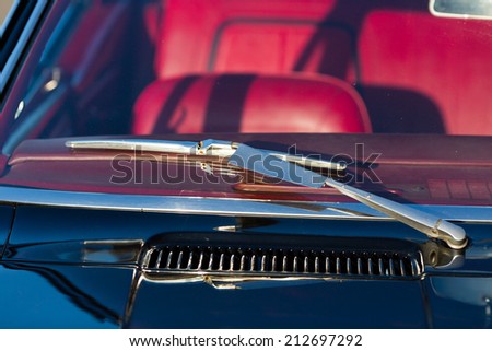 Windscreen and wiper blade of classic American sports car.