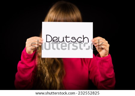 Studio shot of child holding a sign with German word Deutsch - German in English
