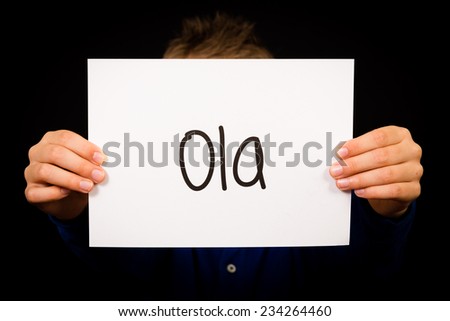 Studio shot of child holding a sign with Portuguese word Ola - Hello