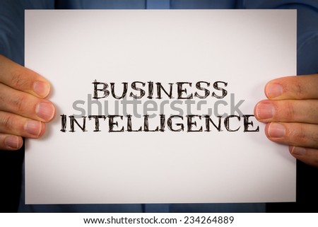 Studio shot of man holding white sign with the words Business Intelligence