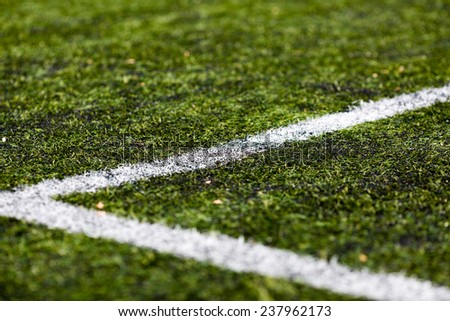 Close-up of artificial green soccer turf on a sunny day.