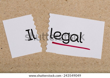 Two pieces of white paper with the word illegal turned into legal