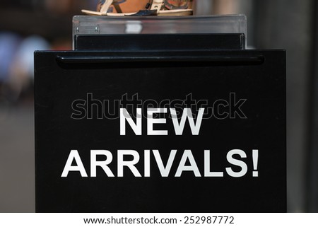 A new arrivals sign outside a footwear store.