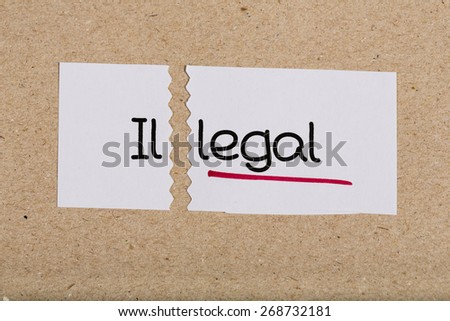 Two pieces of white paper with the word illegal turned into legal