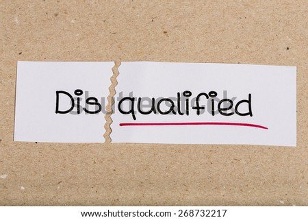 Two pieces of white paper with the word disqualified turned into qualified