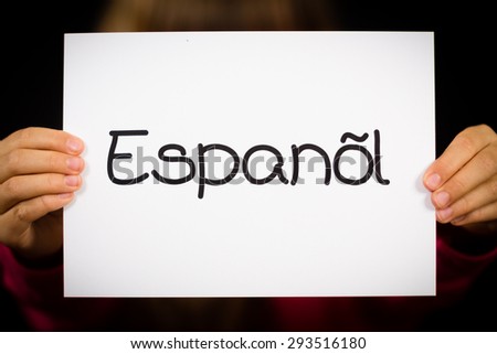 Studio shot of child holding a sign with Spanish word Espanol - Spanish in English