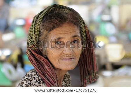 SKUON, CAMBODIA - DEC 22: an unidentified old woman pose for camera at Kampong Cham province,Cambodia on Dec 22, 2011