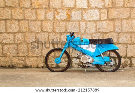 Old, vintage, blue motorbike abandoned on the Croatian street.