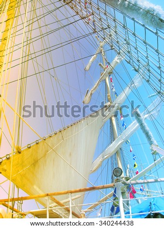 Big sails of sail ship.  Details of the mast and sail from an old sailing ship with red -  blue gradient effect.