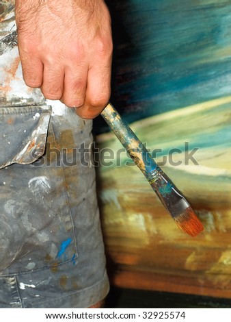 Closeup of the painter\'s creative moment of thinking during his  work..