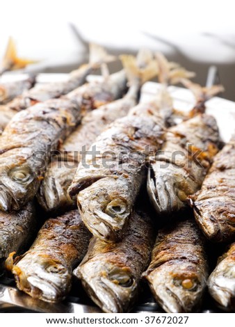 Fresh grilled or roasted fish on a heap after firing...High-key image.
