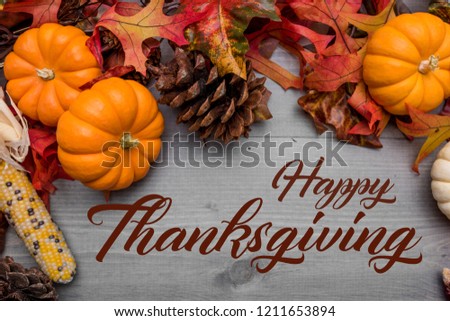 Fall, autumn pumpkins, leaves and veggies on a wooden background. Thanksgiving theme.