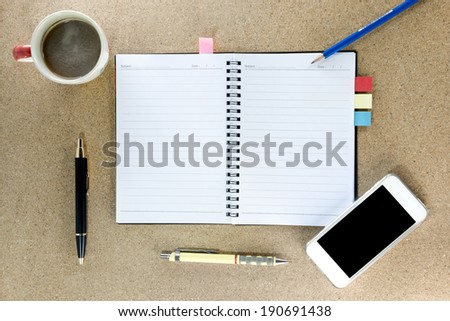 phone,notebook, pen and cup of coffee on work table top view