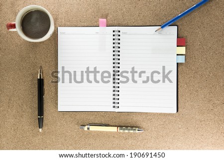 notebook, pen and cup of coffee on work table top view