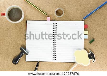 notebook, pen,brand pump and cup of coffee on work table top view