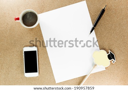 Workplace with phone,paper, pen and cup of coffee on work table top view
