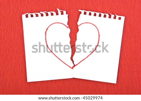Heart drawn on torn notebook page on red background