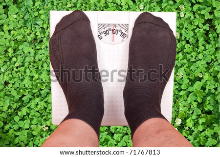 Weighing scales on green grass