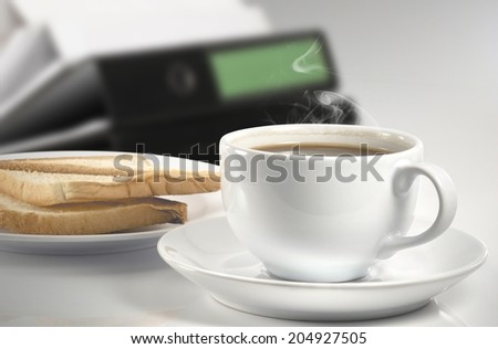 Cup of coffee and toasted bread on the table.