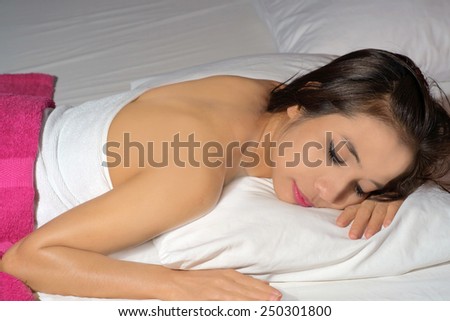 Young pretty woman sleeping on bed at night.