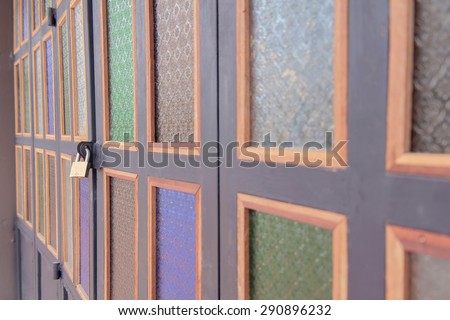 Close up abstract color door with lock, the stained glass decorations on the door.