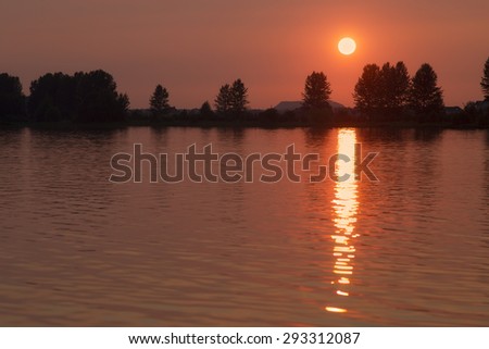Red sunset over the lake before sunset paint the most vivid. The sun makes the light path sunset over the lake.
