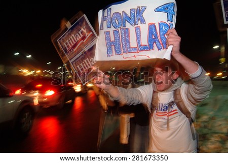 Hillary Clinton supporters wave signs at passing motorists in Manchester, New Hampshire, on January 7, 2008, the night before the New Hampshire primary.