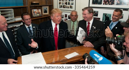 Donald Trump files papers to run in the New Hampshire presidential primary on Nov. 4, 2015. To his far right is New Hampshire Secretary of State Bill Gardner.