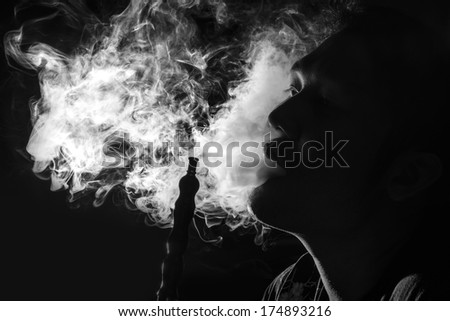 Man Inhaling from a Hookah Man Inhaling from a Hookah