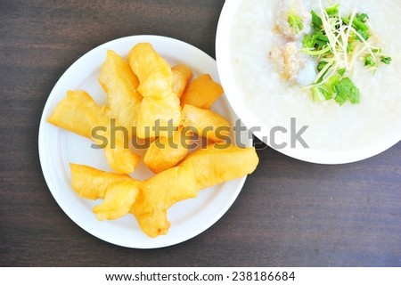 Traditional Chinese porridge rice gruel whit deep-fried dough stick.