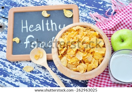 Corn flakes in bowl and small blackboard,healthy food.