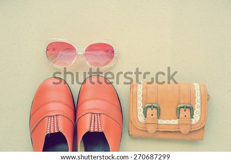 Vintage leather shoes ,leather wallet and fashion eye wear on wood background.