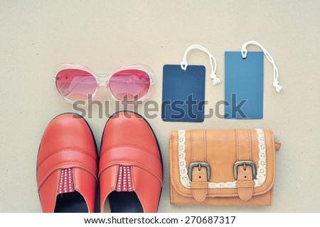 Vintage leather shoes ,leather wallet,fashion eye wear and tag on wood background.