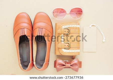 Vintage of leather shoe , leather bag,eye wear,leather bag and tag price on wood background.
