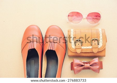 Vintage leather shoes ,leather wallet,fashion eye wear and belt on wooden floor.